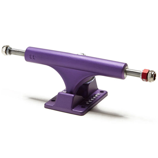 A purple metal skateboard truck with silver hardware and a red lock nut, shown on a clean white background.