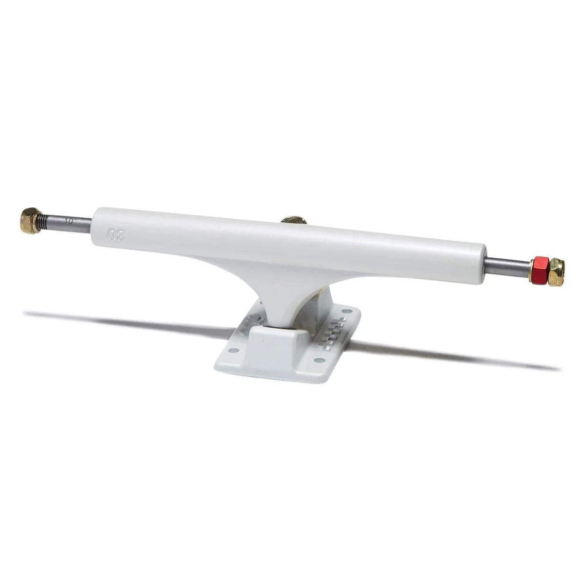 A single white skateboard truck with a white baseplate, featuring a silver metal axle with brass-colored end caps and a small red locknut, shown on a clean white background.