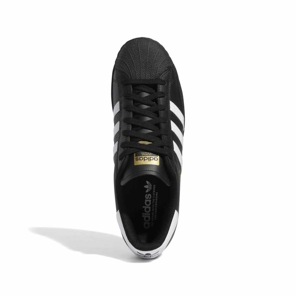 Black Adidas sneaker with white stripes on a white background