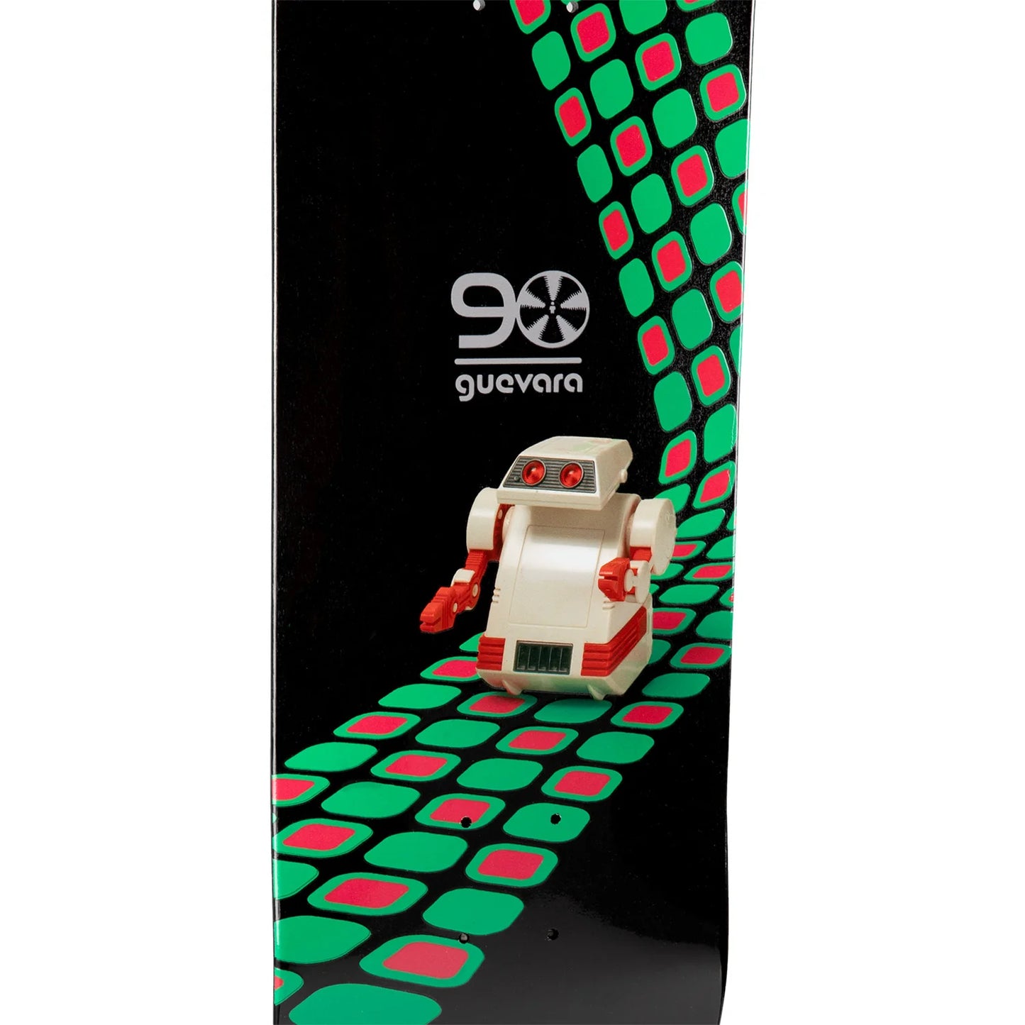 A close-up of a snowboard featuring a black base with a green and pink geometric pattern, a white and red 90 Guevara logo, and a small toy robot graphic.