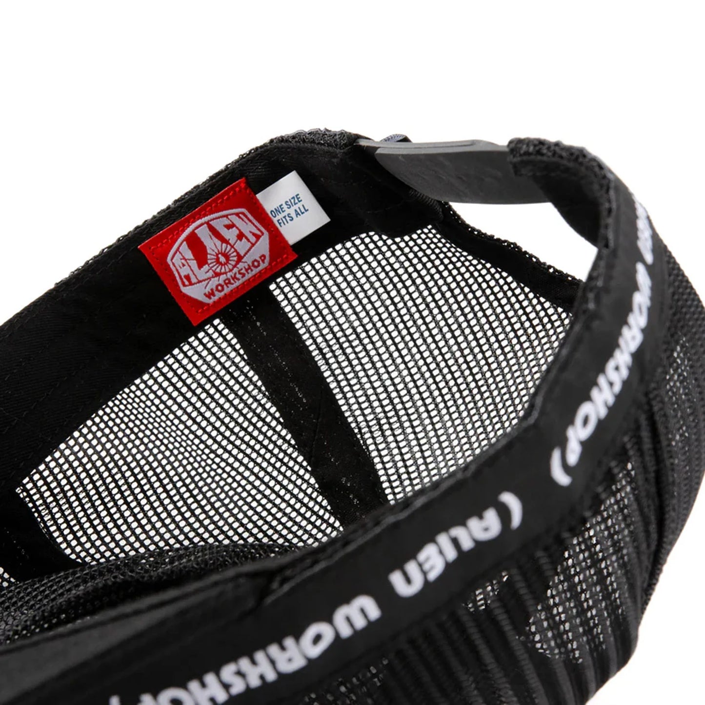 Close-up of a black mesh bag with a red label on a white background