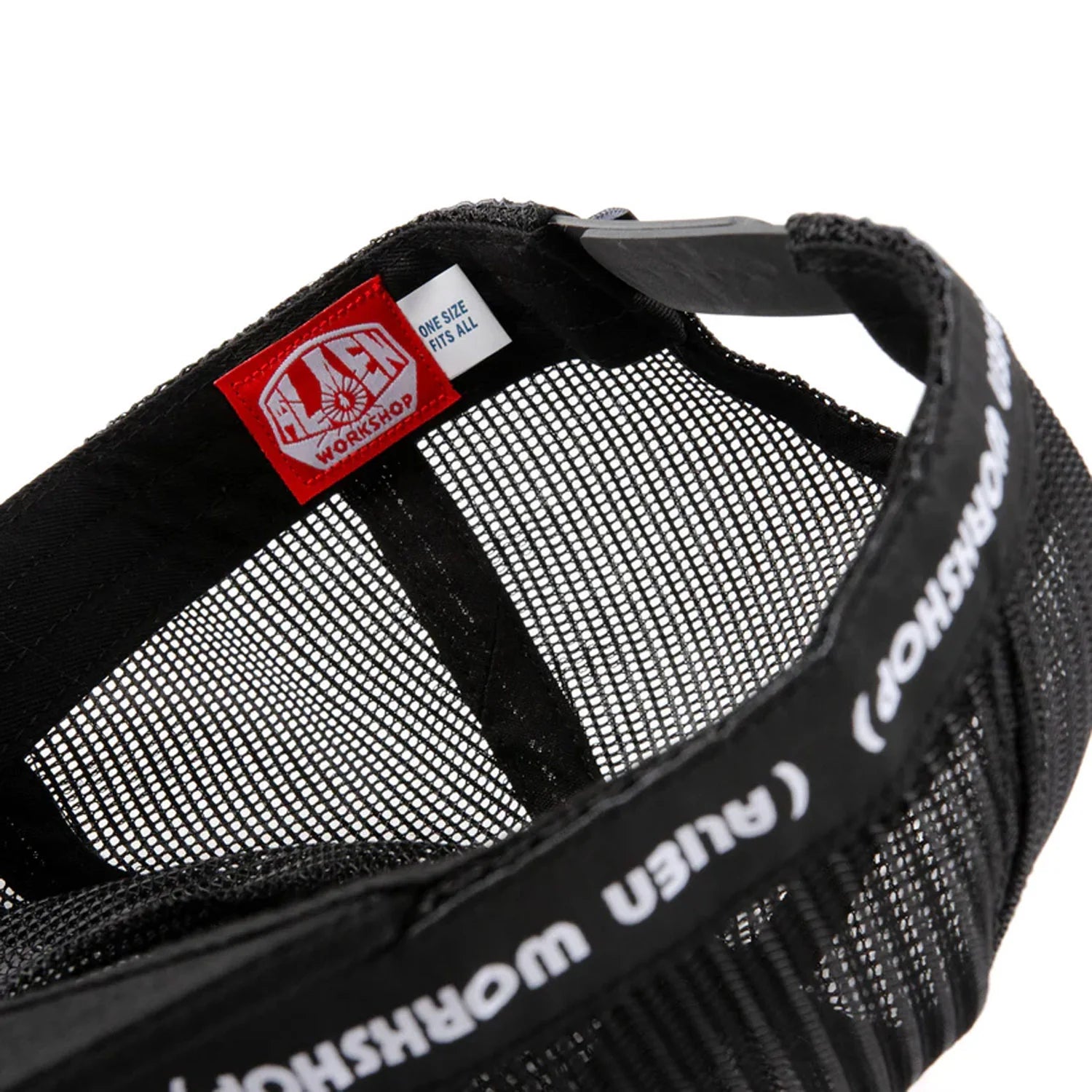 Close-up of a black mesh bag with a red label on a white background