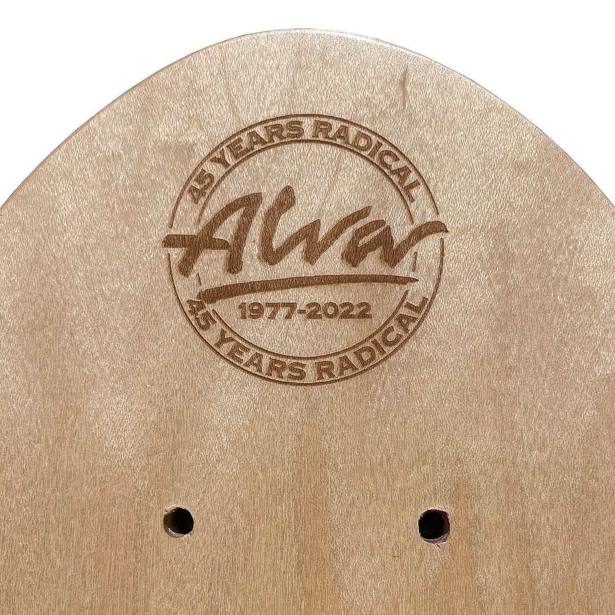 Close-up of a light natural wood skateboard deck showing the engraved Alva 45 Years Radical 45th anniversary logo and two screw holes on a white background.