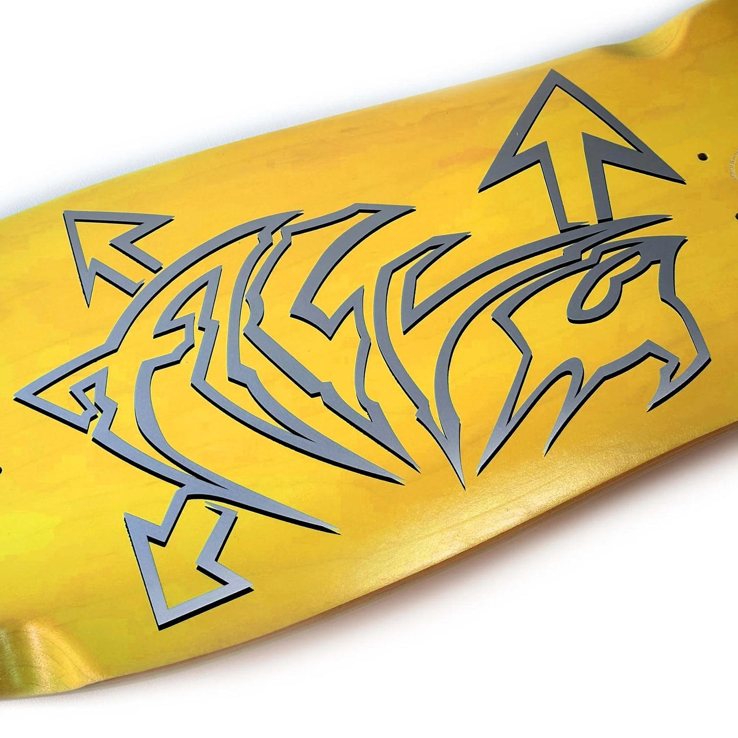 Yellow skateboard deck with gray tribal design on a white background