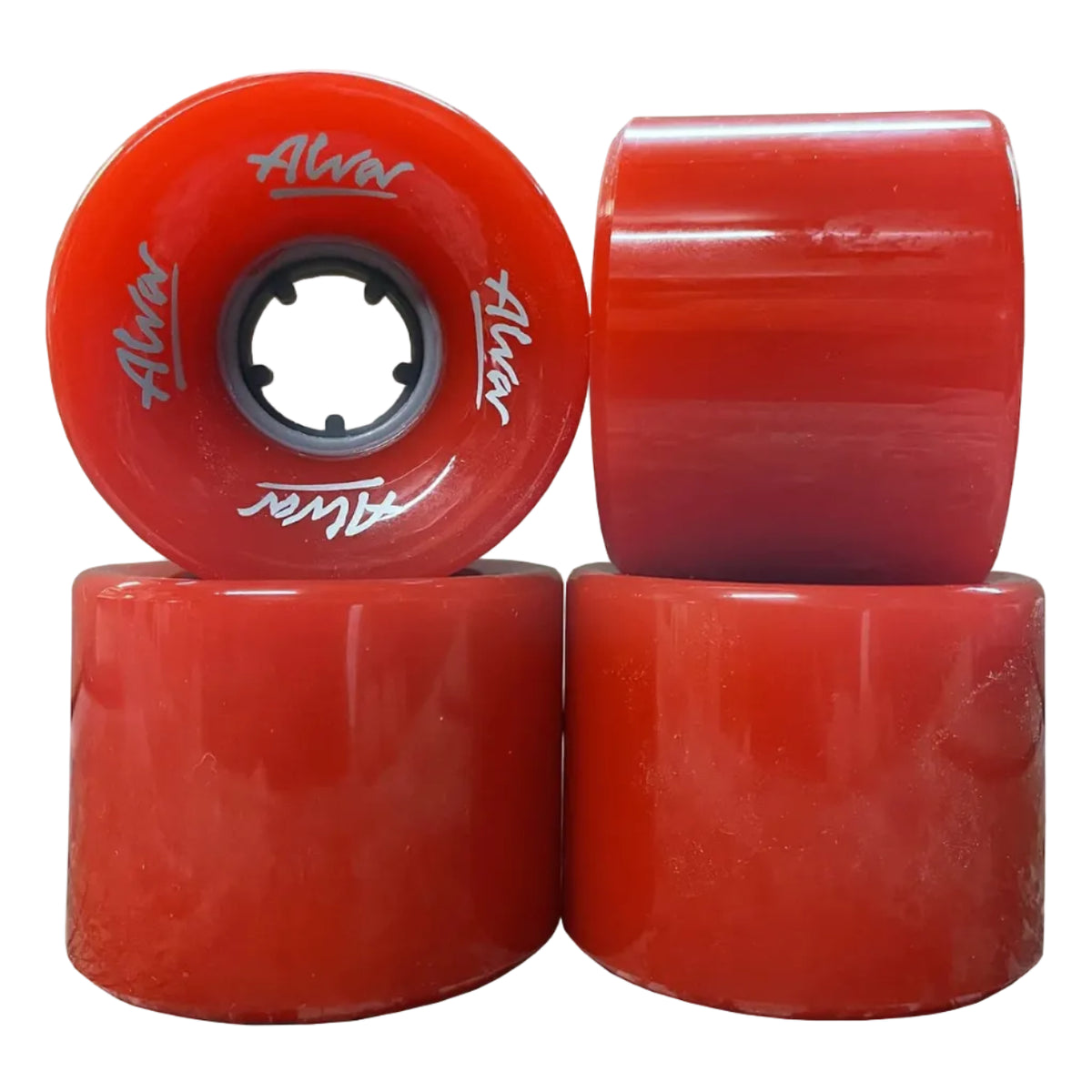 Four red longboard wheels with black inner bores, featuring white 'Alvar' branding, arranged in a stack on a white background.