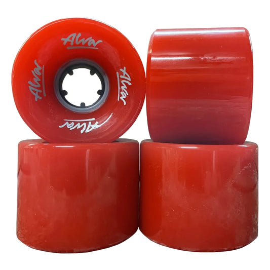 Four red longboard wheels with black inner bores, featuring white 'Alvar' branding, arranged in a stack on a white background.