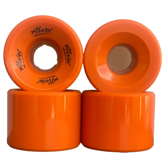 Four orange skateboard wheels with 'Alva' branding on a white background