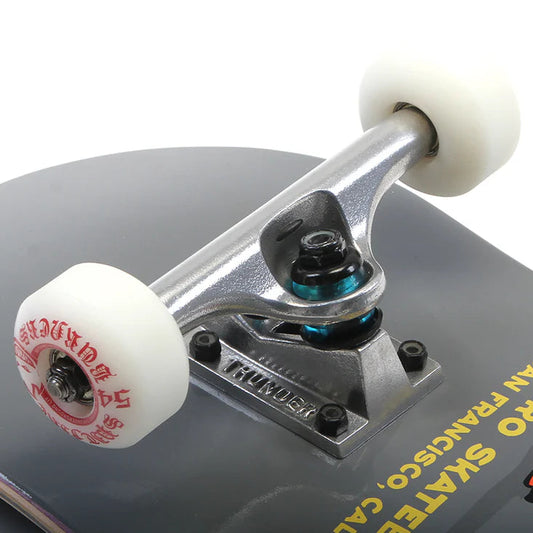 Close-up of a skateboard truck and wheels with a blurred background