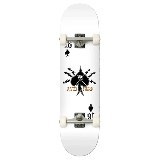 A white skateboard deck featuring a black spade graphic with a skull and crossed arrows, the text 'anti HERO' in gold, and black playing card suit symbols near the corners. The deck is shown from a top-down view with white wheels and silver trucks against a light gray background.
