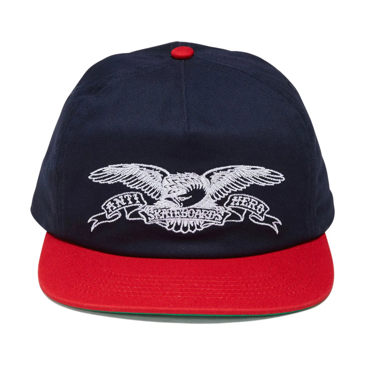 A navy blue snapback cap with a red flat brim and a red top button, featuring a white embroidered eagle and banner logo on the front. The brand text on the banner reads 'ANTI HERo WORLDWIDE'.
