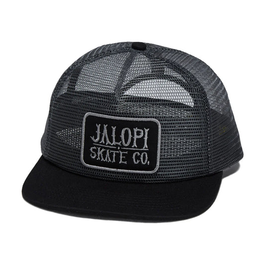 A black trucker hat with a black mesh back and a black flat brim, featuring a rectangular patch on the front that reads 'JALOPI SKATE CO.' in white text.