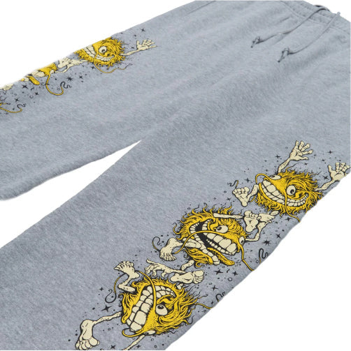 Gray sweatpants with yellow cartoon lion designs on a white background