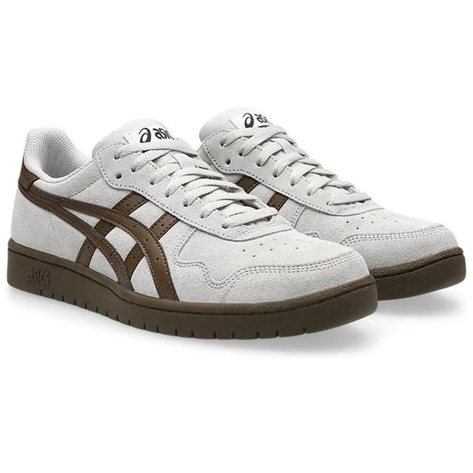 Gray sneakers with brown accents on a white background