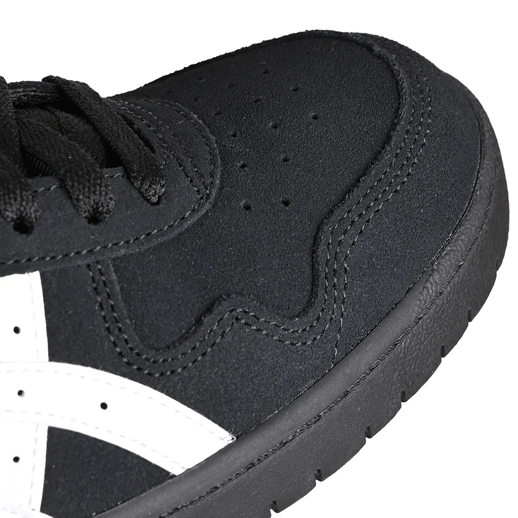 Close-up of a black sneaker with white sole on a white background