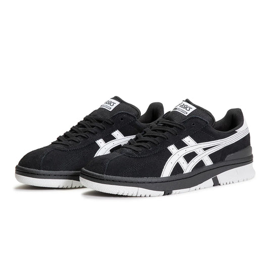Black and white sneakers with a prominent brand logo on a white background