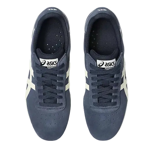 Pair of navy blue sneakers with white accents on a white background