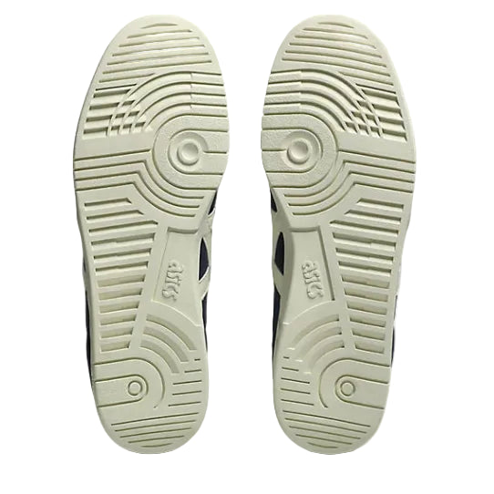 Close-up of the soles of a pair of shoes with a brand logo on a white background