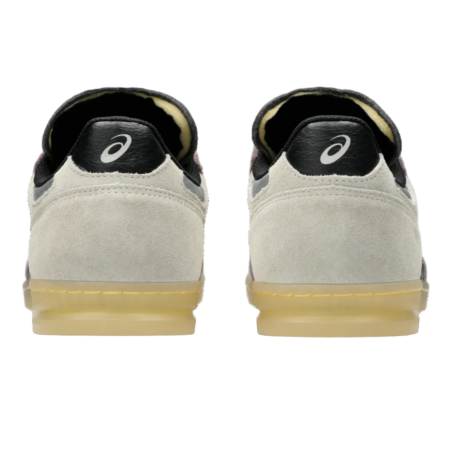 Back view of beige sneakers with black soles on a white background