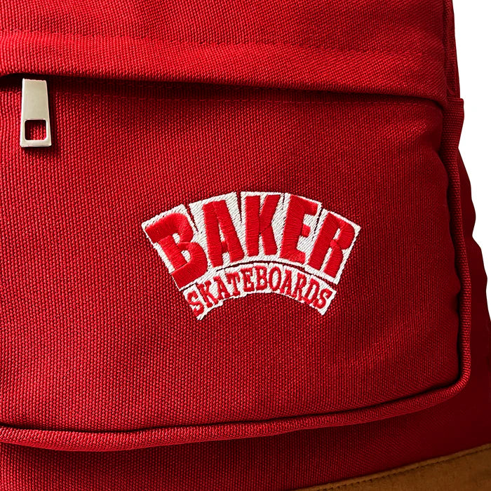 Red backpack with 'Baker Skateboards' logo on a white background