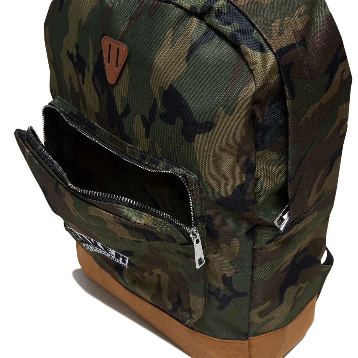 A camouflage backpack with a green, brown, and black camo pattern, featuring a tan leather-like triangular logo patch on the front and a brown base, shown with an open front zip pocket on a white background.