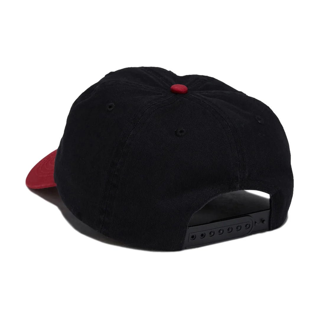 A black baseball cap with a red visor and a red button on top, shown from a rear three-quarter angle against a white background.
