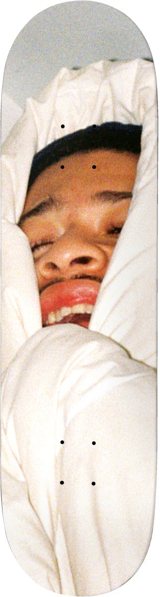 Person wrapped in a white blanket with a gray background