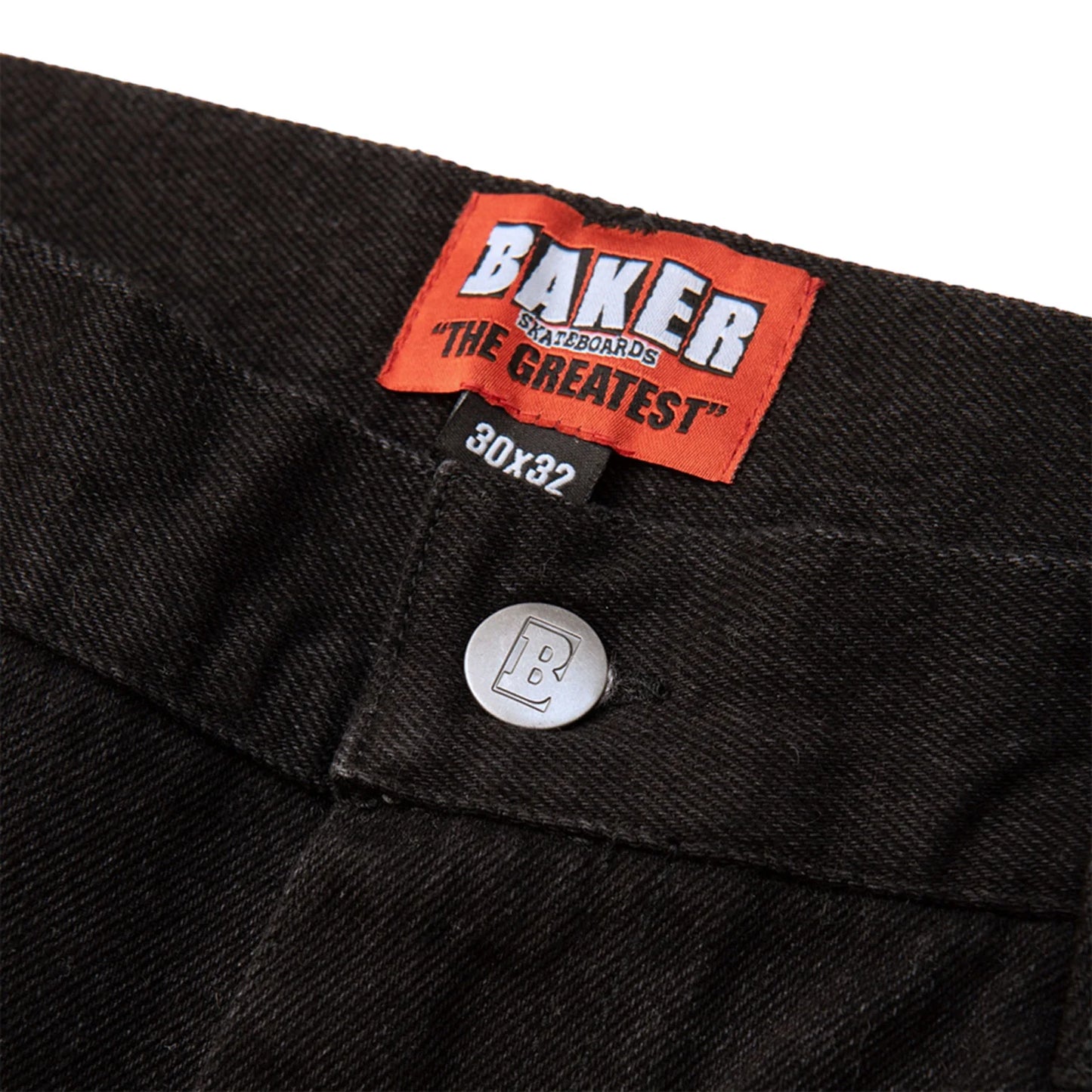 Close-up of a black denim pocket with a Baker brand label on a white background