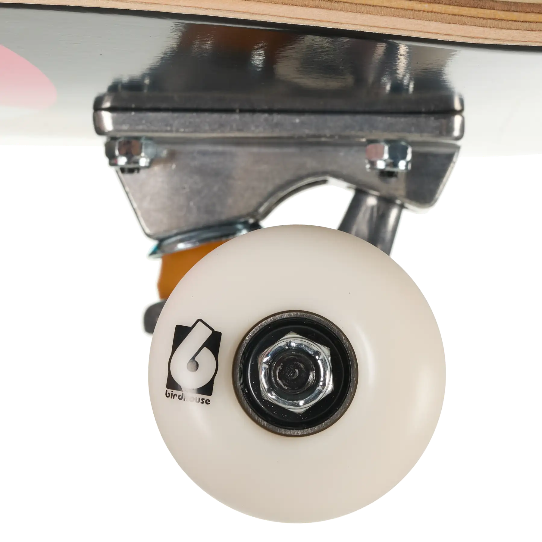 Close-up of a skateboard wheel and truck assembly, showing a cream-colored wheel with a black logo, a silver metal truck, and part of the wooden deck against a white background.
