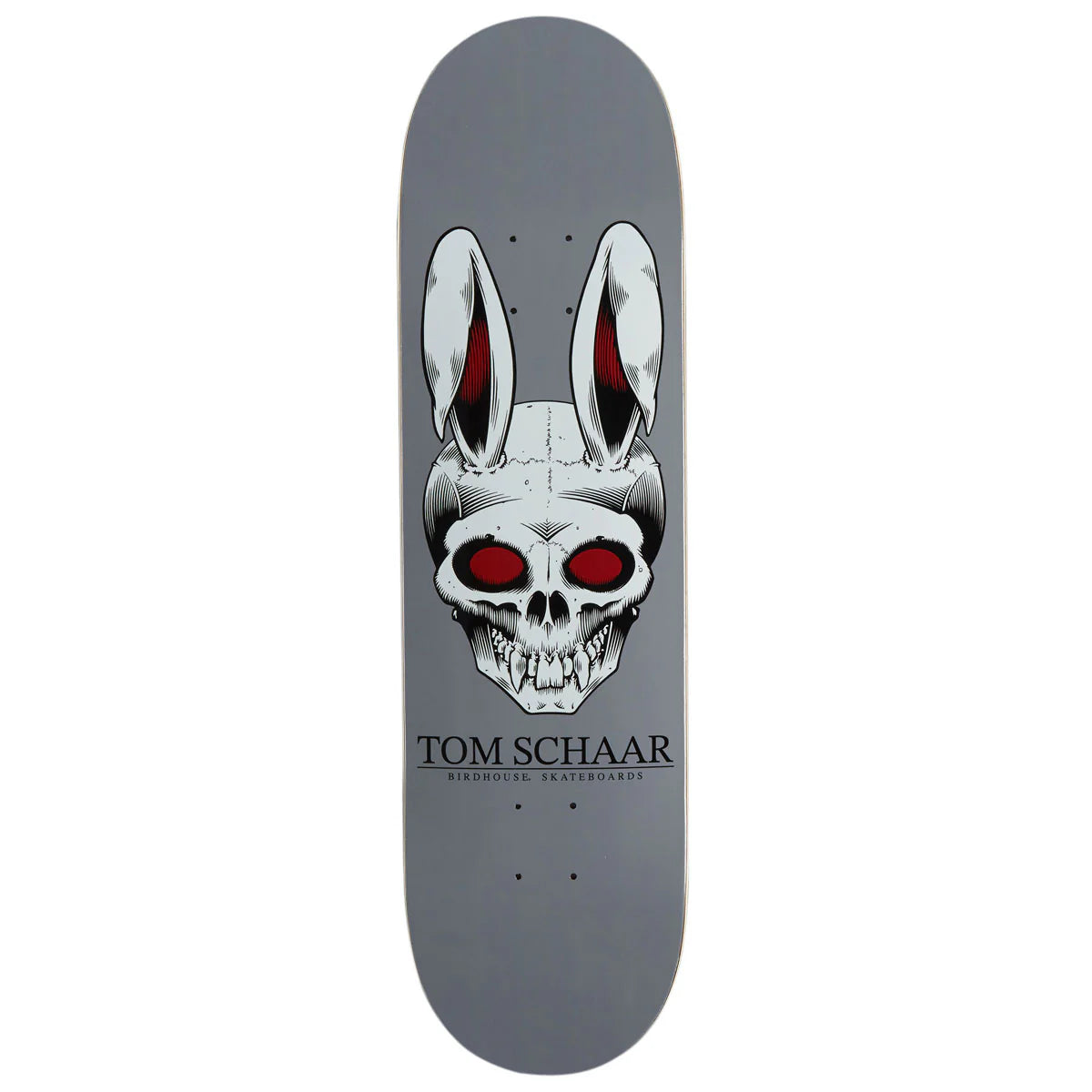 A Tom Schaar skateboard deck featuring a gray background with a large graphic of a skull wearing bunny ears with red eyes, and the text 'TOM SCHAAR' printed below.