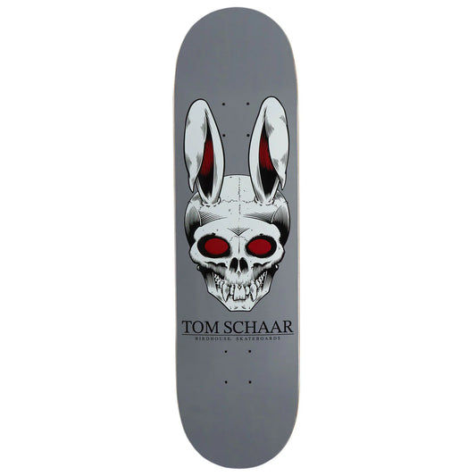 A Tom Schaar skateboard deck featuring a gray background with a large graphic of a skull wearing bunny ears with red eyes, and the text 'TOM SCHAAR' printed below.