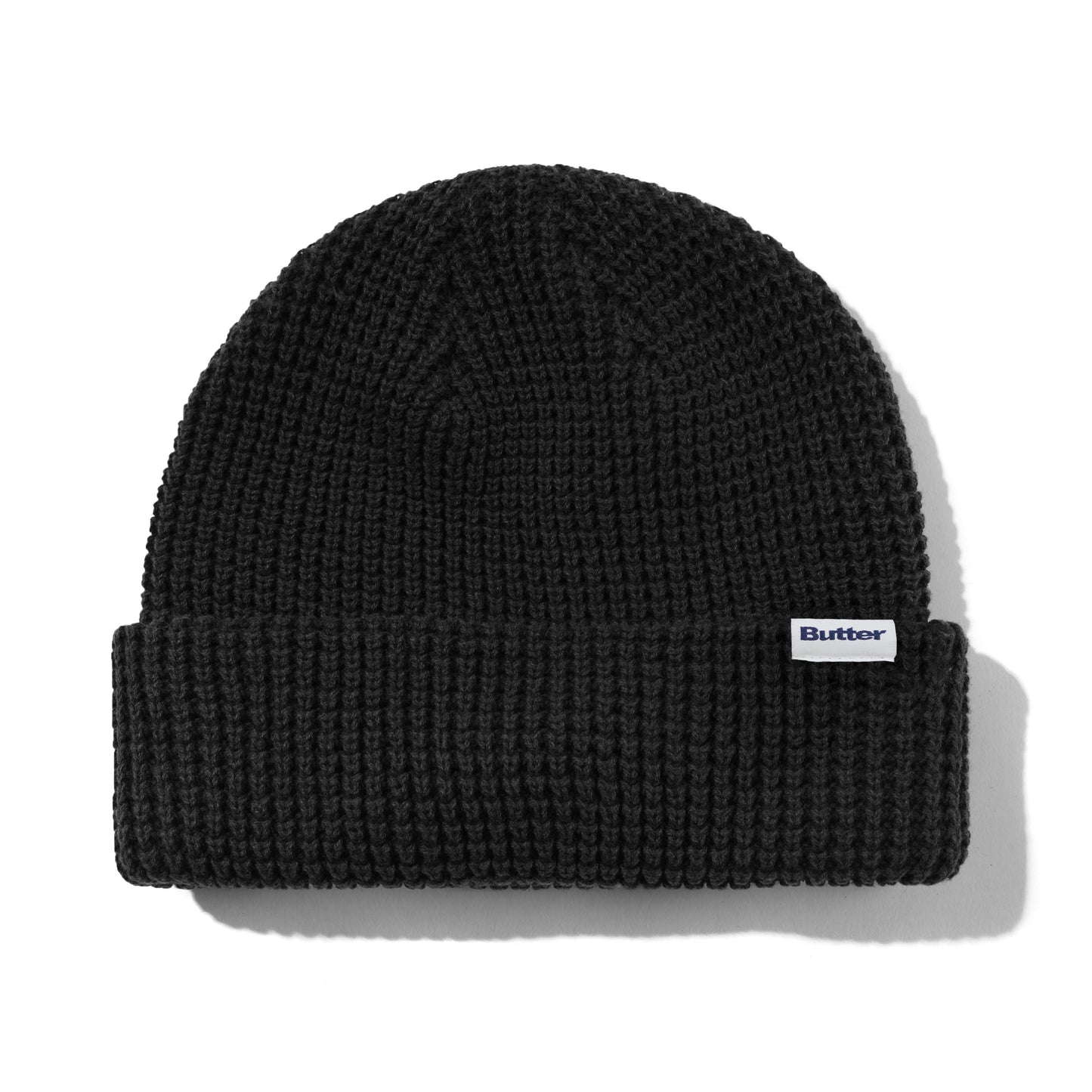 Black knit beanie with a brand logo on a white background
