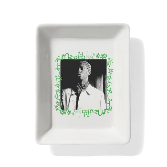 White square plate with a black and white photo and green text on a white background