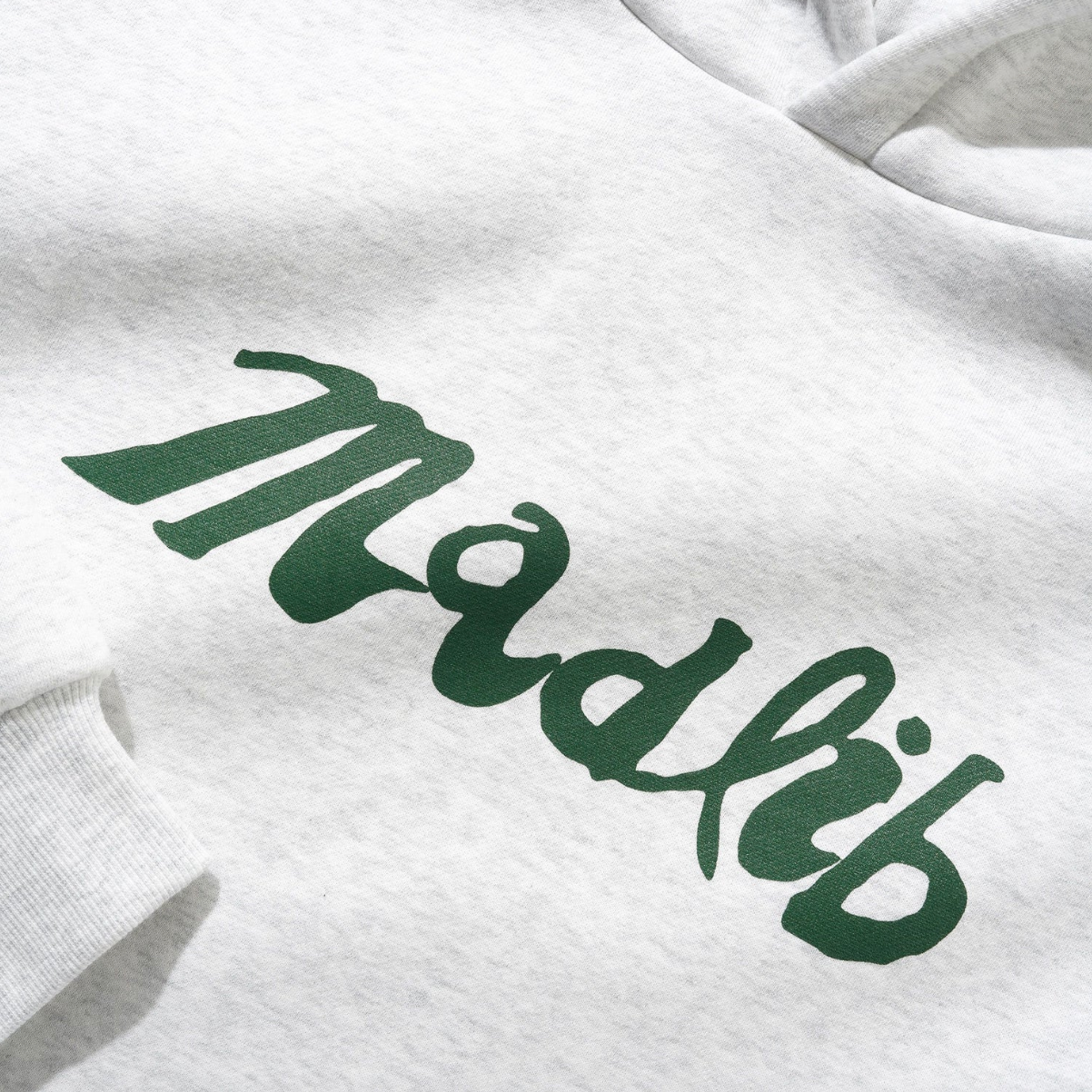 White sweatshirt with green 'Mödlif' text on a white background