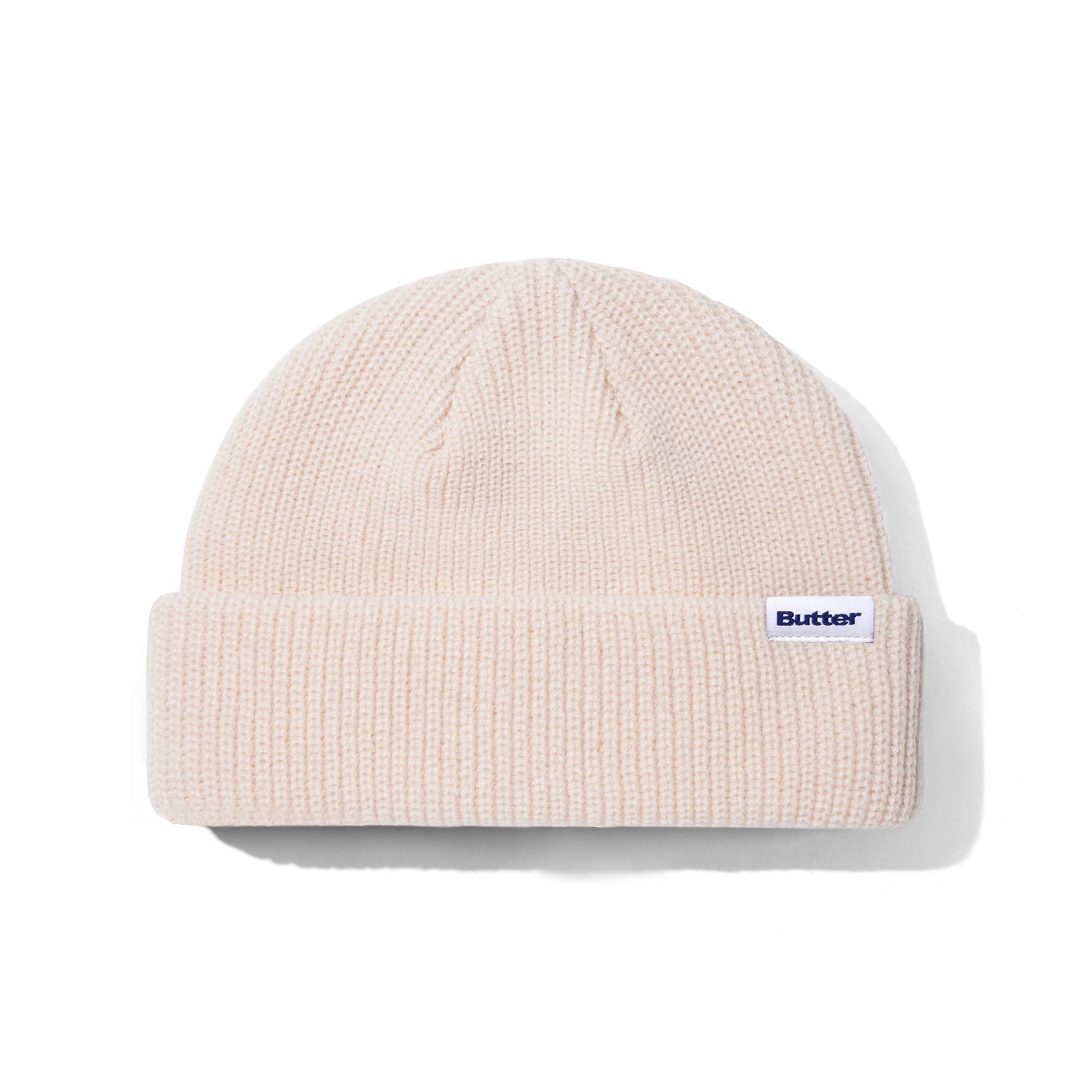 Beige knit beanie with a brand logo on a white background