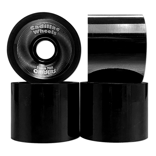 Black skateboard wheels with visible branding on a white background