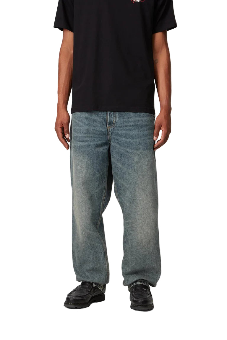 Person wearing light blue jeans and a black t-shirt on a white background