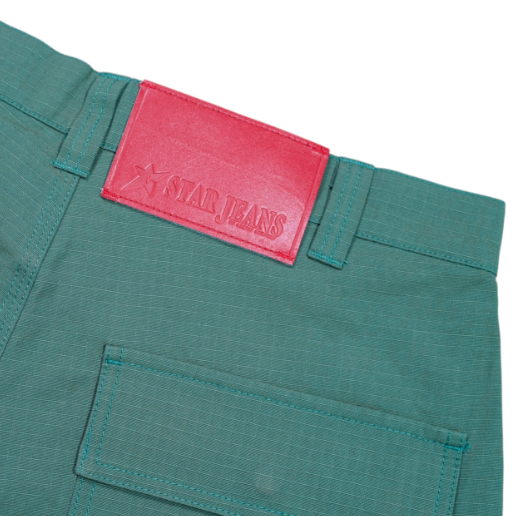 Green pants with a red 'Star Jeans' label on a white background