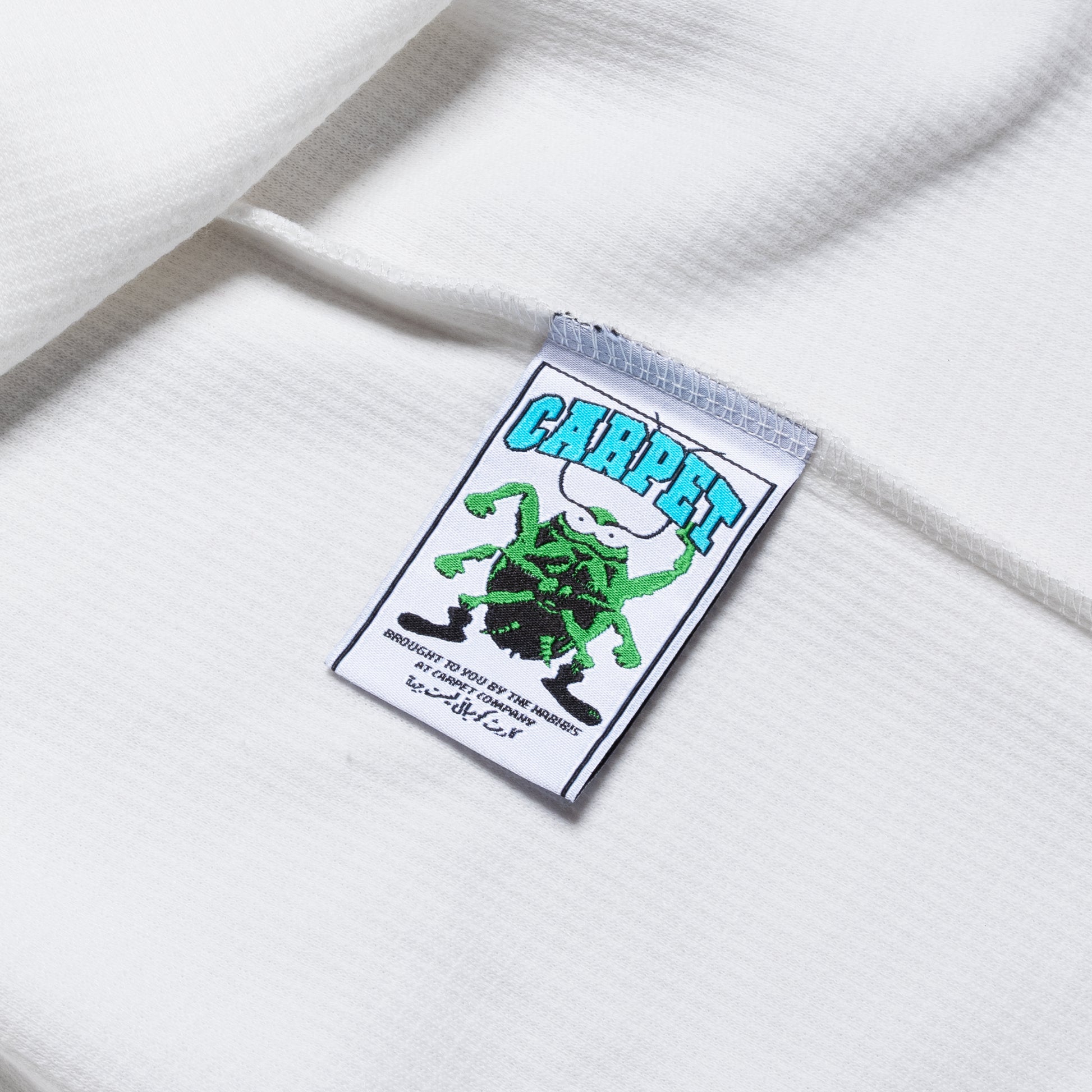 Label with a green spider design and 'Carpet' text on a white background