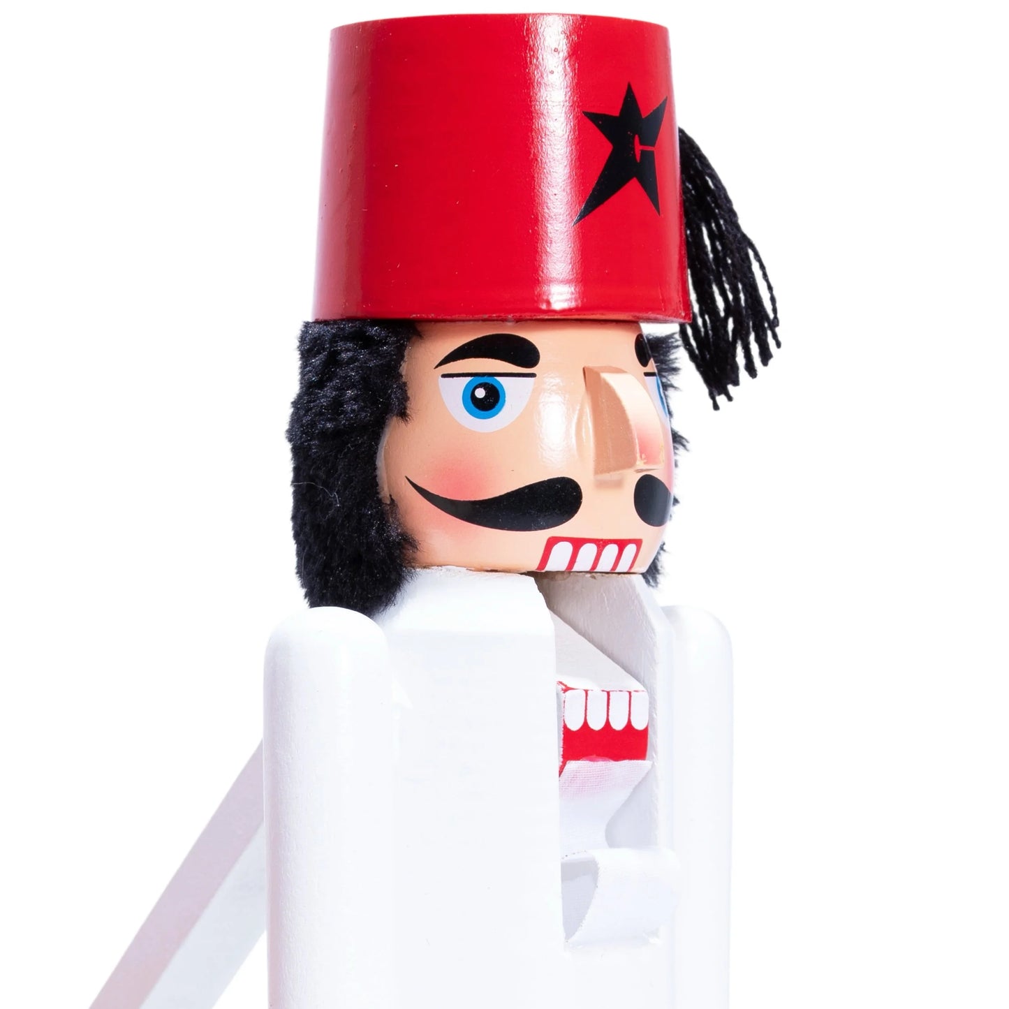 Nutcracker figurine with a red hat and black star on a white background