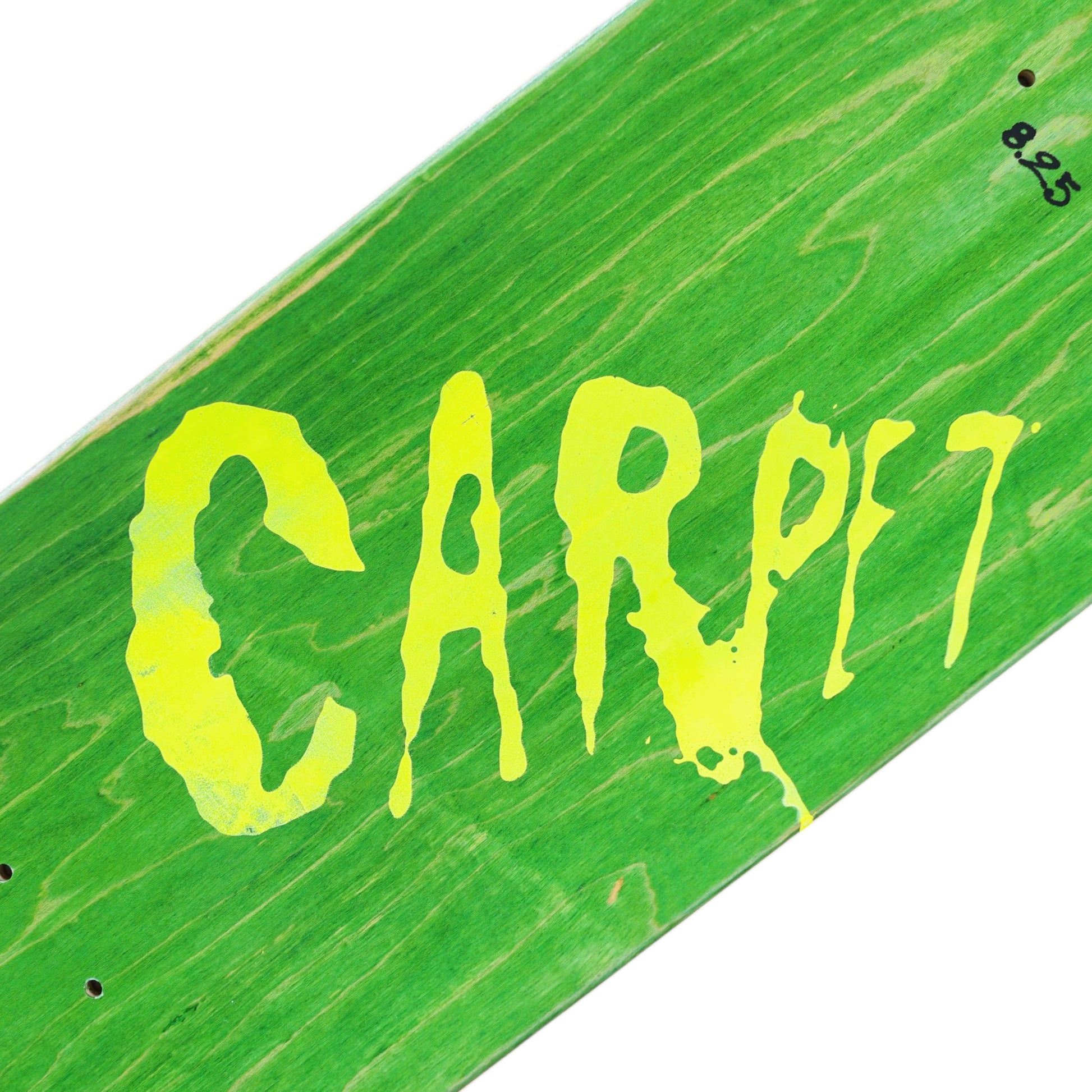 Green skateboard deck with 'CARPET' in yellow text on a white background