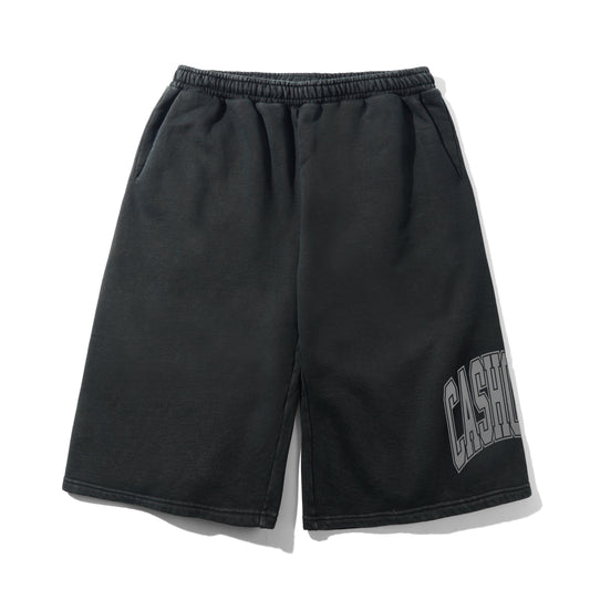 Black sweat shorts with an elastic waistband and a gray arched 'CASH' graphic on the lower left leg, displayed flat against a white background.