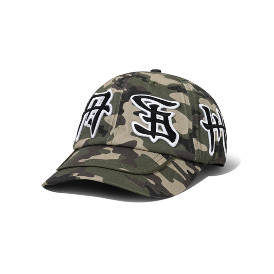 A baseball cap in a green and brown camouflage pattern, featuring three stylized black and white embroidered characters on the front panels, set against a plain white background.