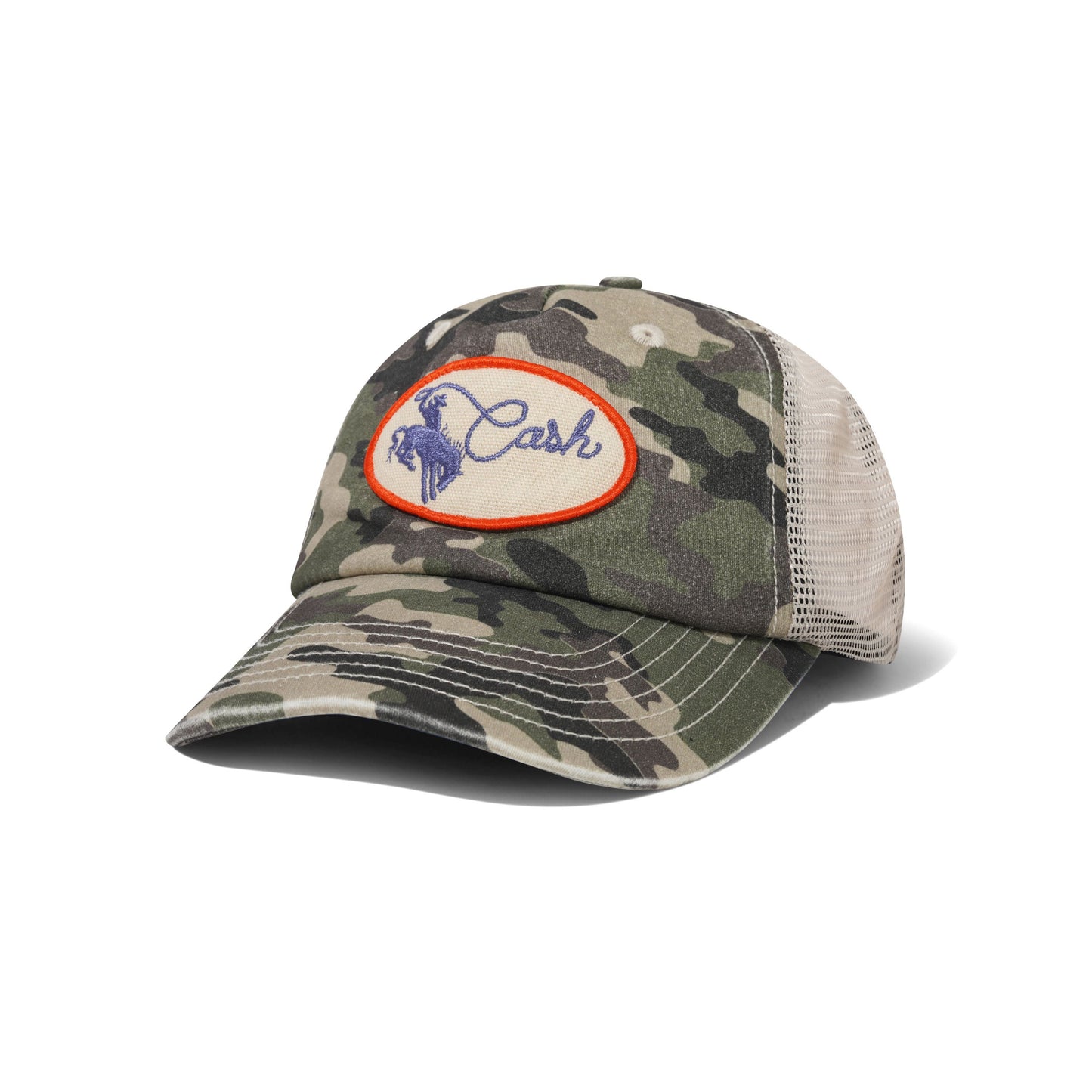 A camouflage trucker cap with a beige mesh back and a circular embroidered patch on the front featuring the brand name 'Cash' in blue with a horse logo inside an orange border.