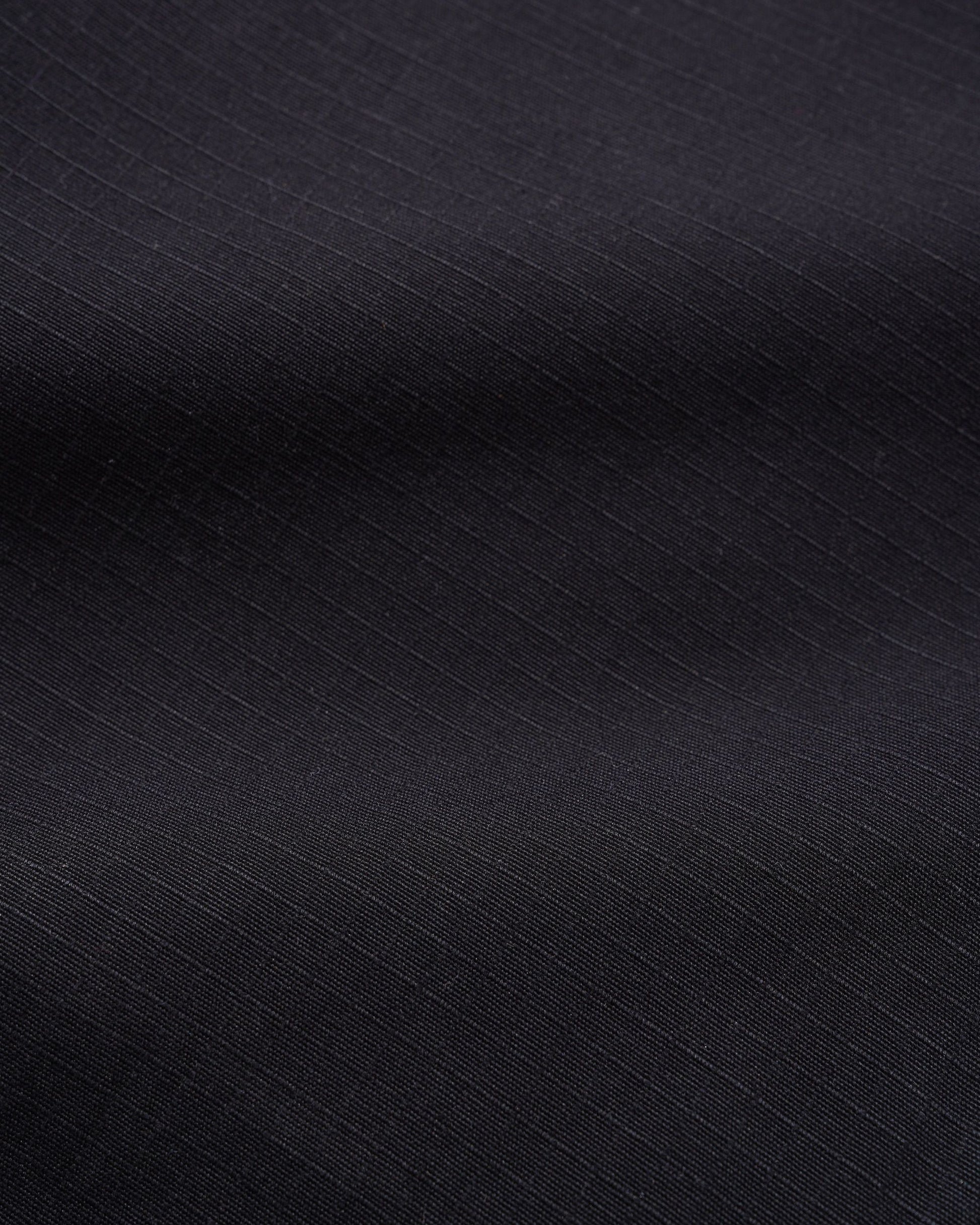 A close-up of dark charcoal gray fabric with a subtle diagonal ribbed texture.