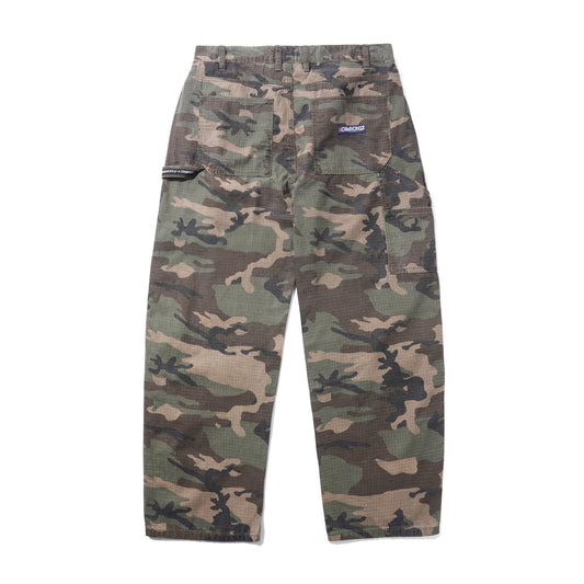 A pair of Patagonia camouflage cargo pants shown flat against a solid white background. The pants feature a classic woodland camo pattern in shades of green, brown, and beige, with a small blue Patagonia logo patch on the upper right hip.