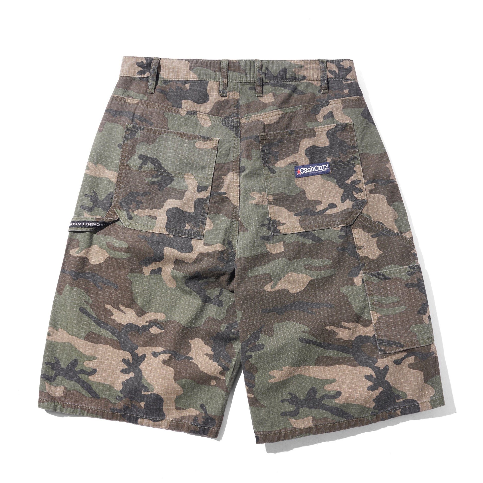 A pair of camouflage cargo shorts with a green, brown, and tan camo pattern, featuring a small blue and white 'One True North' logo patch on the back pocket, displayed flat against a white background.