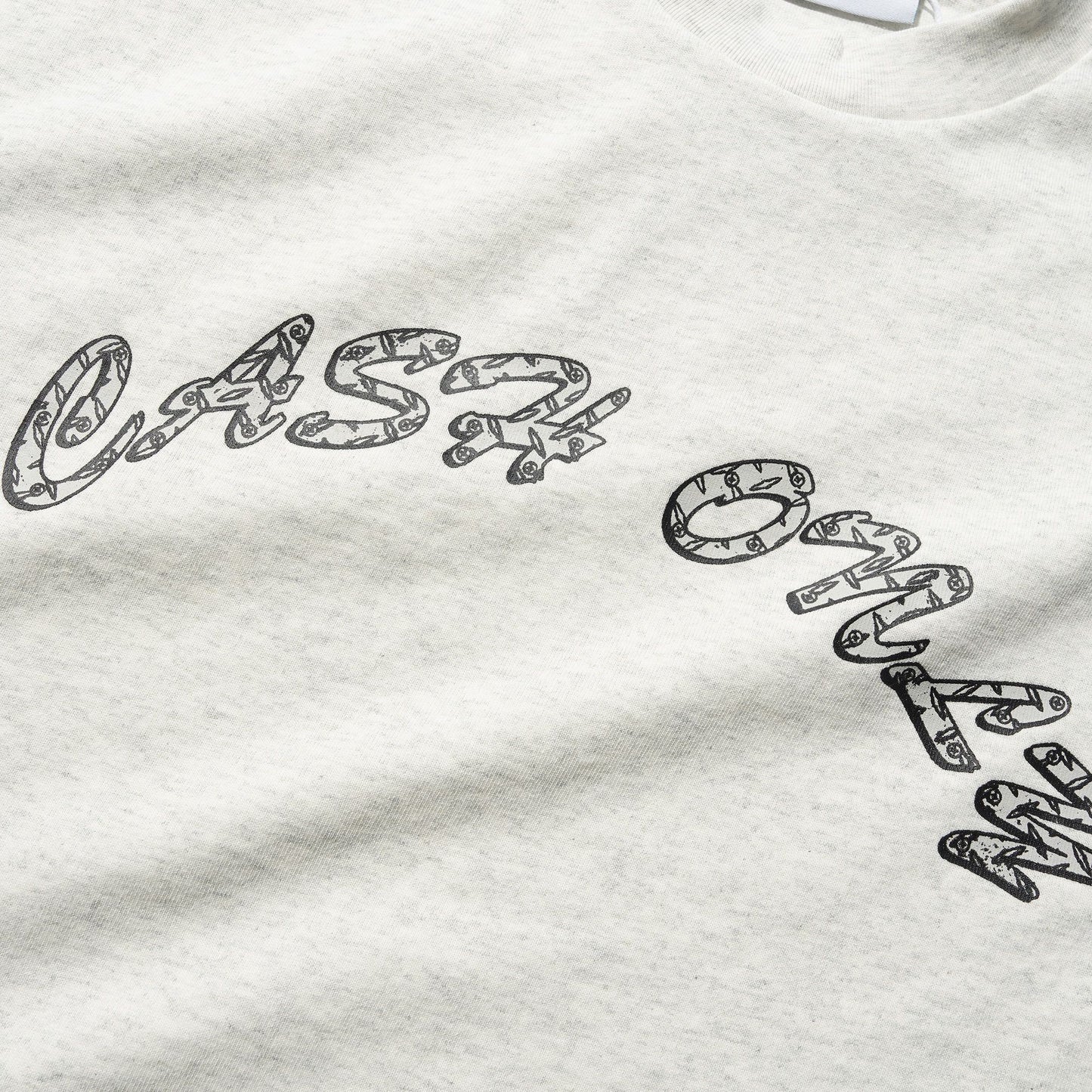 Grey sweatshirt with black text and a visible brand logo on a white background