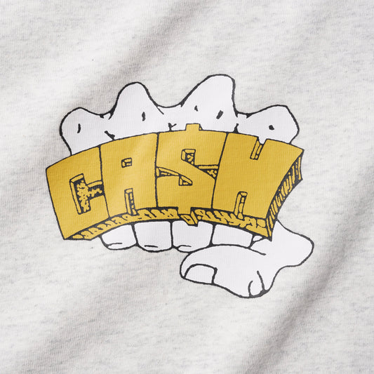 A close-up of a light heather gray t-shirt featuring a graphic print of a white hand holding a gold 3D block letter 'CASH'.