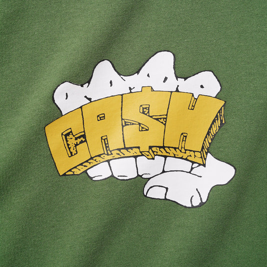 A close-up of a green fabric garment featuring a graphic print of a white hand holding a yellow 3D block letter 'FASHION'.