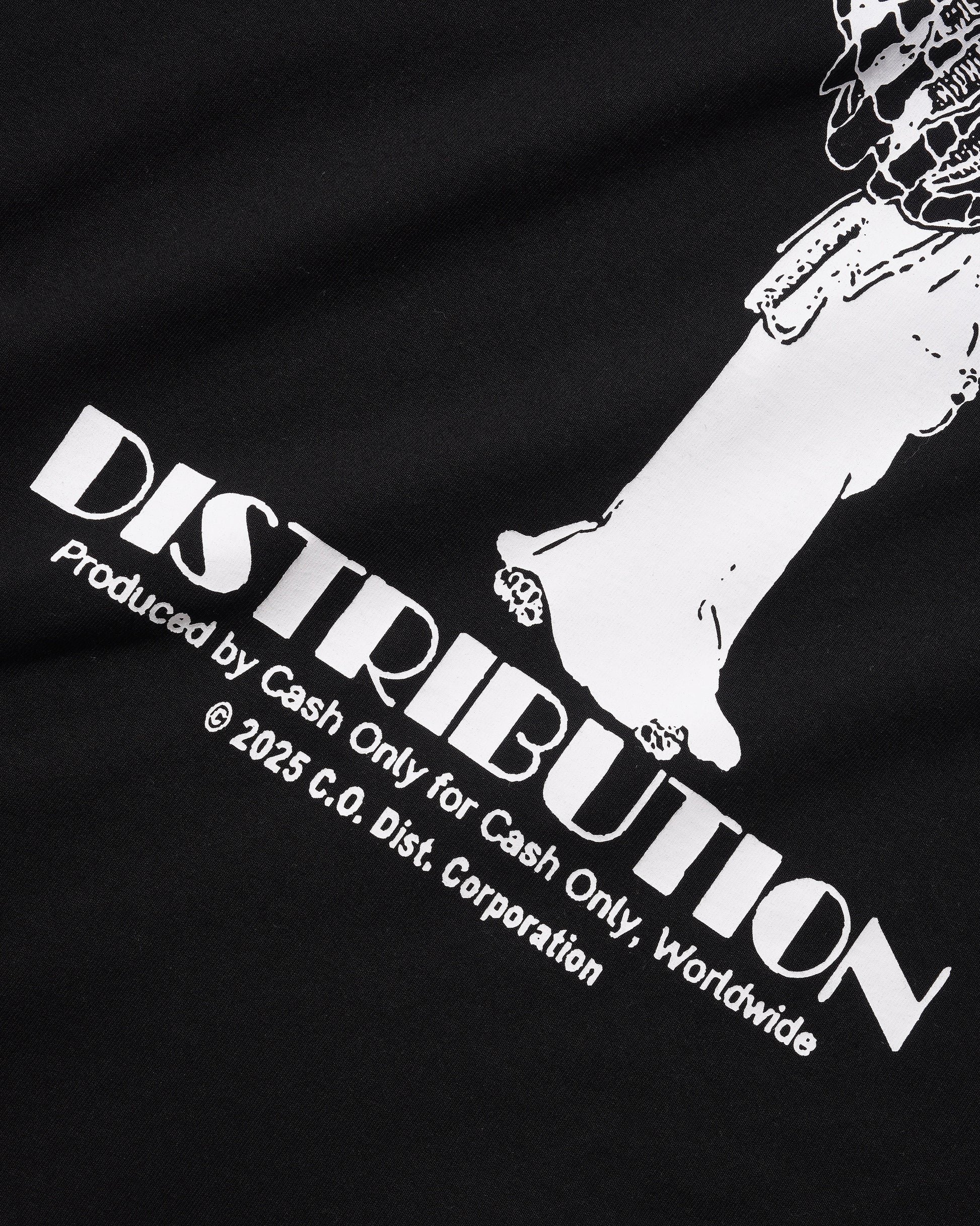 Close-up of a black garment featuring a large white graphic print with the word 'DISTRIBUTION' and smaller text reading 'Produced by Cash Only for Cash Only, Worldwide' and '© 2025 C.O.